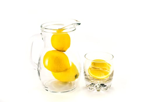 Lemons in jar and glass.