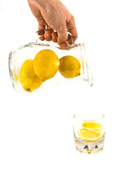 Lemons in jar and glass.