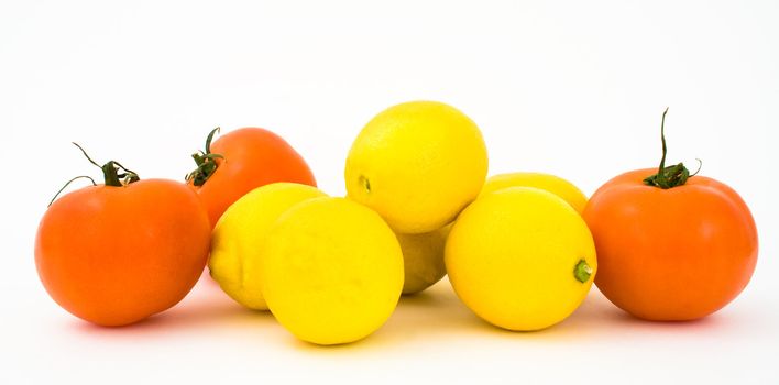 Close up of tomatoes and lemons, isolated on white.