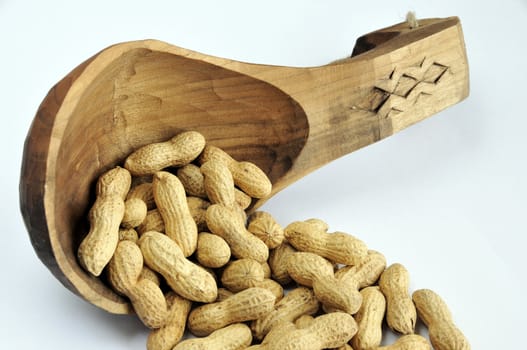 Hand made wooden sponn full with peanuts