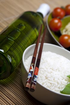 A bowl of perfectly cooked, plain Basmati rice, in an Asian style bowl, with a garnish of Thai Basil