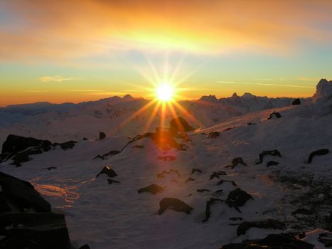 Sunset in snow-covered mountains of Caucasus