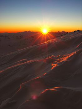 Sunset in snow-covered mountains of Caucasus          