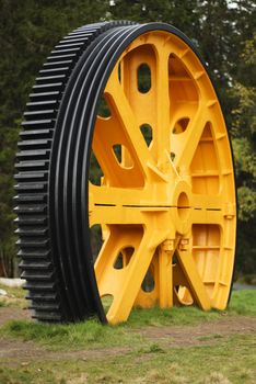 Large gear wheel displayed on top of the mountain Fløyen in Bergen. The gear was used in the machinery for the transportation to the top! Fløyen is a popular tourist attraction to get a overview of Bergen