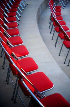 An image of a curved rows of red chairs
