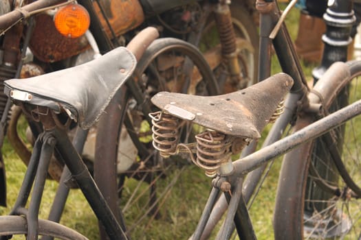 close up shot of the saddles on two old bicycles