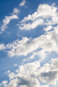 Blue sky and white clouds on sunny day. vertical