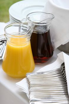 Two jugs with orange and cherry juice