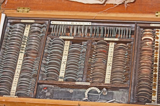 box of old opticians lenses for sight checking