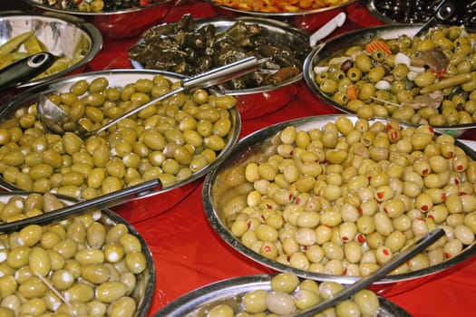 various flavour olives in silver dishes