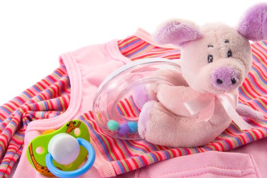 Clothes, toys and soother for a baby, isolated. Copy space.