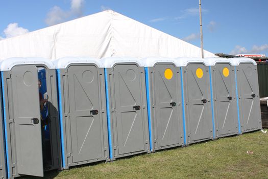 a row of portaloos at a function