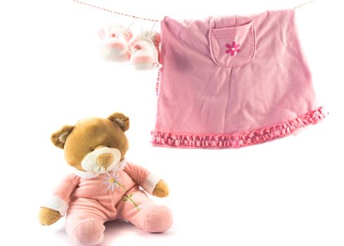 Two pairs of baby's slippers and teddy bear. Copy space