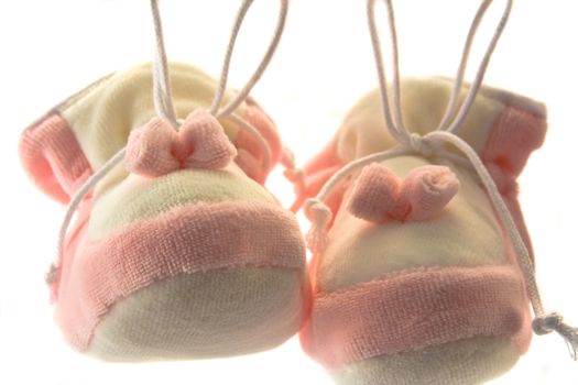 Pair of baby's slippers hanging on a rope. Including copy space.