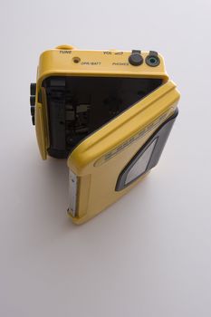 vintage yellow cassette player with door open