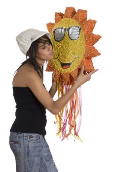 Teenage girl wearing a black tube top, knitted hat and jeans with holes kissing a sunny pinata