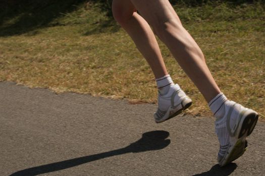 Running feet of a female athlete training.