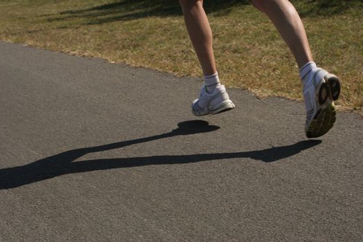 Running feet of a female athlete training.