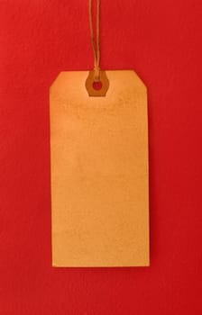 Vintage tag hanging on a red background