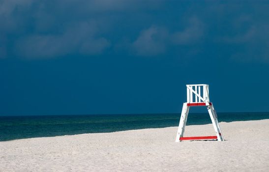 A lifeguard chair sitting on a deserted beach.