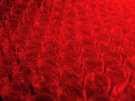 Red bubble wrap with focus in center, for design and background