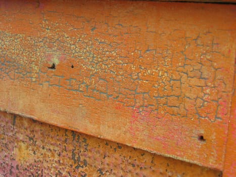 Old pumpkin-colored paint over old blue paint, showing crackling texture from antique age 