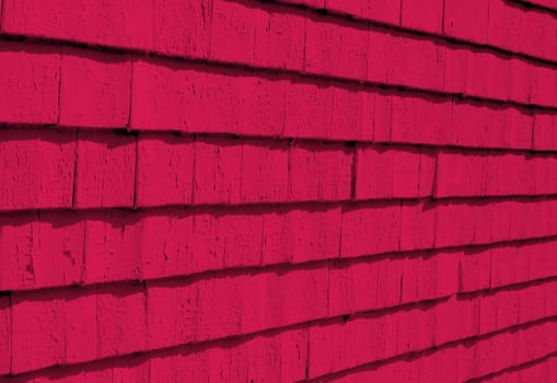 On an old building, shingle siding painted red