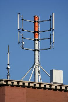 A huge antenna on the rooftop of a former war bunker in a residential area. Electromagnetic pollution, the downside of modern communication technology.