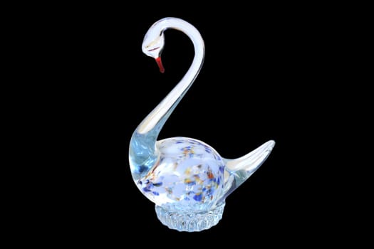 Statuette of swan from glass on black  background.