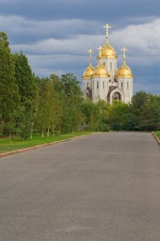 churh with a gold domes, in a blue clouds sky