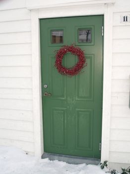 green door with garland decoration