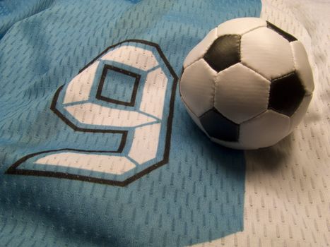 small soccer ball on the nuber nine uniform