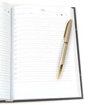 empty appointment book and pen on a white background.