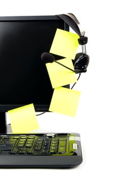 Computer with VOIP headset hanging on the screen, isolated on white background. Internet communications, VOIP (Voice Over Internet Protocol), call-center concepts.