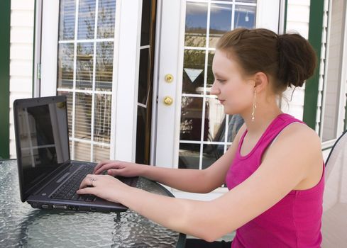 Teen with a laptop doing some homework