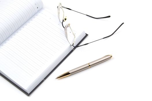 empty daily planner, pen and eyeglasses on a white background