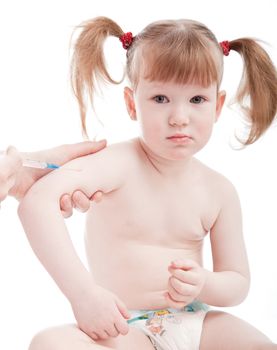 Little caucasian girl in a hospital. Vaccination procedure.