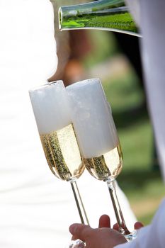 A waiter filled champagne glasses