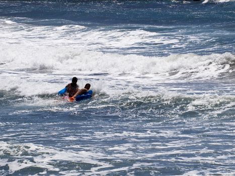 Young adults have fun on the waves