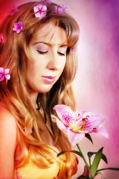 A pretty girl holds a single pink lily flower