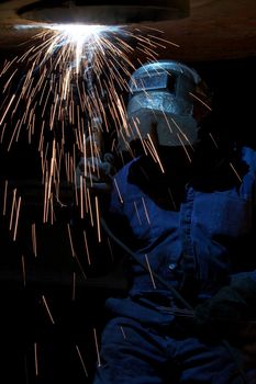 a welder working at shipyard at night