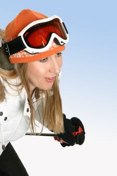 A female wearing warm ski clothing skiing - space for text.
