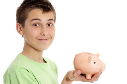 A boy holding a money box.   He is sideways with head turned