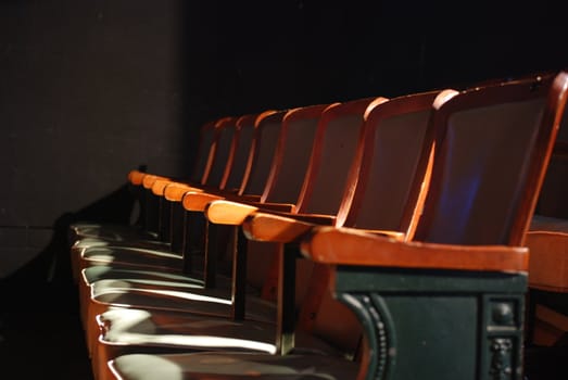 Light hits a row of theater seats.