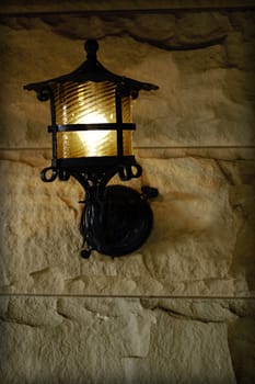 antique sconce on old brick exterior wall