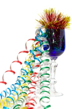 Blue glass on a white background, filled with colorful ribbons