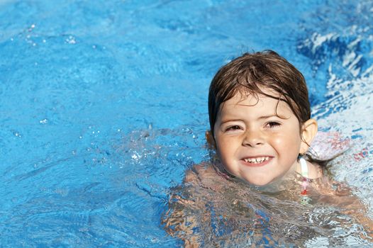 a cute little girl in pool water during the summer