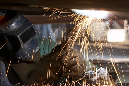 a welder working at shipyard during day