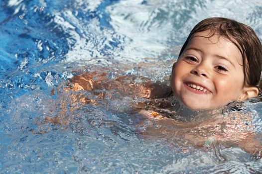 a cute little girl in pool water during the summer