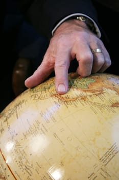 Business man hand pointing at Japan on Globe